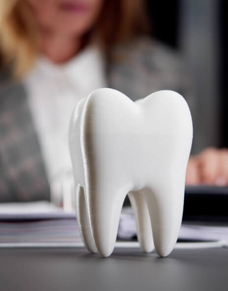 Model of a tooth sitting on desk