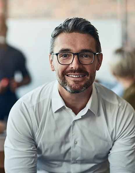 a businessman sitting down and smiling