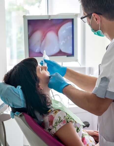 Dentist taking intraoral photos of a patient during dental exam