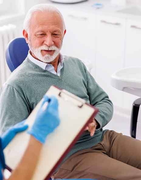 a man consulting with his dentist in Arlington