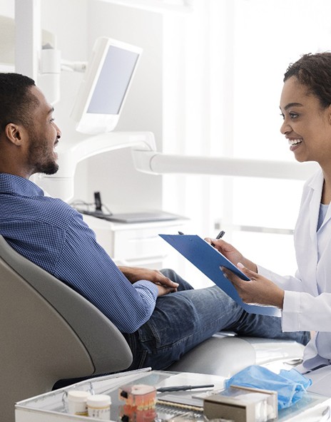 Dentist discussing with patient how to treat gum disease in Arlington 