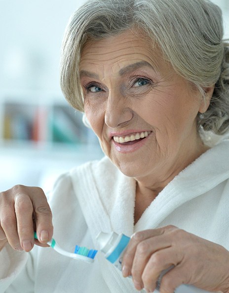 Woman practicing dental implant care in Arlington