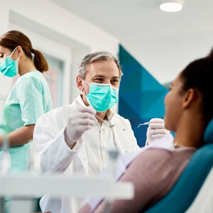 Dentist treats patient