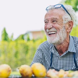 Man smiles outdoors